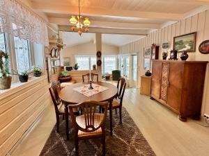 a dining room with a table and chairs at Cozy cottage at the Atlantic coast in Leknes