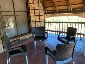 a group of chairs sitting on a porch at Kruger Nest in Marloth Park