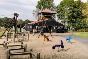 a playground with a play equipment in the sand at Enterbrook in Enter