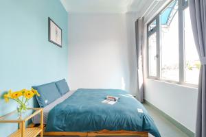 Postel nebo postele na pokoji v ubytování Kim Little Hotel Dalat