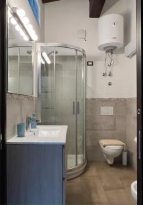 a bathroom with a shower and a sink and a toilet at Casa Ziretto in Castelmola