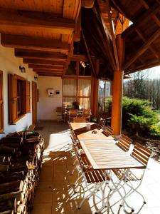 a patio with tables and chairs under a pavilion at Kiskúti Vendégház in Monoszló