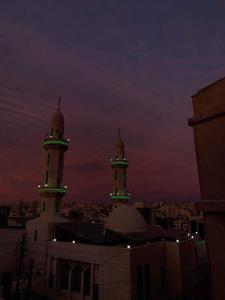 two towers on top of a building at night at Iyad apartment in Amman