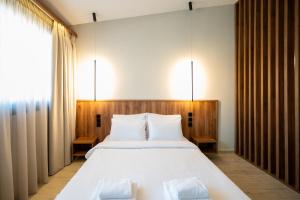 a bedroom with a large bed with two white pillows at Dwell House 5 in Ioannina