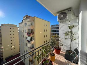 einen Balkon mit Topfpflanzen und Gebäuden in der Unterkunft Cherry Apartment in Durrës