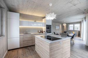 a kitchen with a large island in a room at Lumen by coliving in Renens