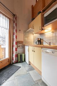 a kitchen with white appliances and a window at "L'Ancolie" Appartement de Charme 4 Personnes à Val Cenis in Termignon