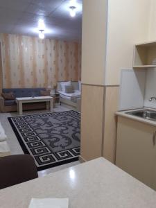 a kitchen and living room with a couch and a table at Lind Guest House B&B in Gyumri