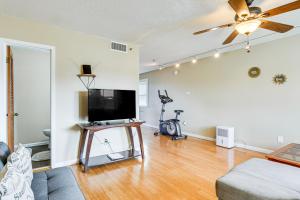 a living room with a flat screen tv and a couch at Panama City Waterfront Escape Fenced Yard and Dock! in Panama City