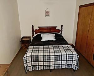 a bedroom with a bed with a black and white blanket at 3 Bed House in Niagara Falls in Niagara Falls