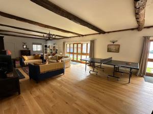 a living room with a ping pong table in it at The Granary - Wood Farm Barn. Luxury Barn with wonderful countryside views in Bawdeswell