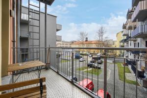 uma varanda com um banco e vista para uma rua em home2stay Apartmenthaus Dresden em Dresden