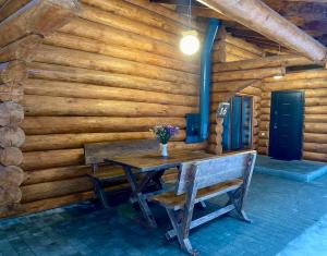 a wooden room with a wooden table and chairs at Resort Stariy Prud in Filippovichi