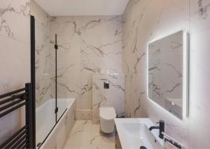 uma casa de banho com um lavatório, um WC e um espelho. em Spacious Luxury Penthouse, 2BR, Private Parking em Windsor