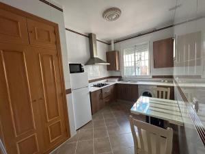 a kitchen with a white refrigerator and a counter top at Hostal Cueva De Los Frailes in Algámitas +11 photos