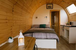 a bedroom in a log cabin with a bed at Easkey Glamping Village in Easkey