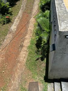 a stone bench sitting on the side of a garden at Residence Loisirs in Pereybere