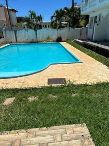 a large blue swimming pool in a yard at Residence Loisirs in Pereybere