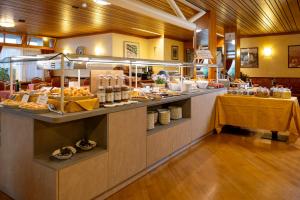 a buffet line with food on display in a restaurant at Miravalle in San Lorenzo in Banale