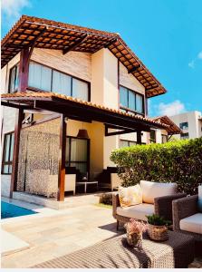 a house with a patio and a swimming pool at Bangalô Boutique com piscina Privativa in Porto De Galinhas +28 photos