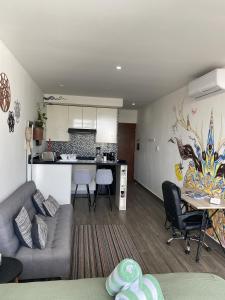 a living room with a couch and a kitchen at Precious Studio w/ working station in Playa del Carmen