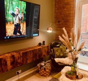 a living room with a flat screen tv on a wall at The Fifth Quarters, Grade II Listed Apartment, The Lace Market, NG1, City Centre, Nottingham, Sleeps 4 in Nottingham