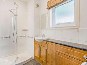 a bathroom with a sink and a shower at 5 Bed in Dunkeld 90585 in Dunkeld
