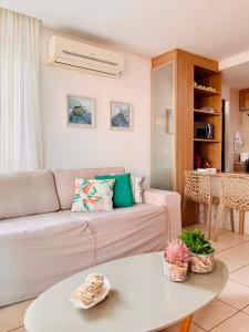 a living room with a couch and a table at Bangalô Boutique com piscina Privativa in Porto De Galinhas