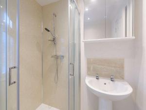 a white bathroom with a sink and a shower at 2 Bed in Okehampton 85432 in Okehampton +50 photos