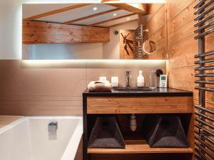 a bathroom with a sink and a bath tub at Chalet Avoriaz, 6 pièces, 10 personnes - FR-1-314-161 in Morzine