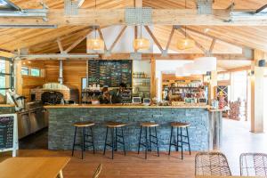 a bar in a restaurant with stools at Huttopia Southern Maine in Sanford