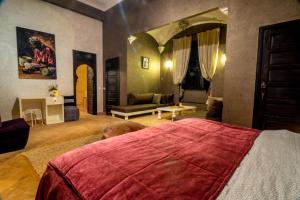 a bedroom with a large bed and a living room at Villa Septha in Marrakesh