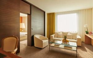 a living room with a couch and a table at InterContinental Genève by IHG in Geneva