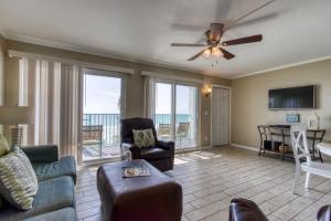 a living room with a couch and a ceiling fan at The New Hotel Collection Beachfront in Clearwater Beach