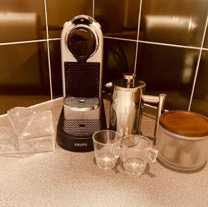 a kitchen counter with a blender and glasses on it at The Fifth Quarters, Grade II Listed Apartment, The Lace Market, NG1, City Centre, Nottingham, Sleeps 4 in Nottingham