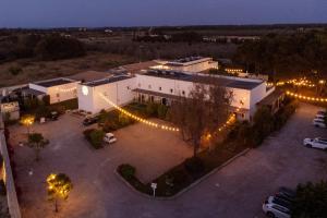 an overhead view of a building with lights in a parking lot at Masseria Rauccio in Torre dell'Orso