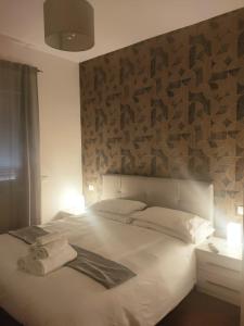 um quarto com uma cama branca e toalhas em Il covo dei Briganti em Roma