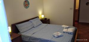 a bedroom with a bed with two towels on it at Smart Apartment by the Sea near Palermo, Sicily in Isola delle Femmine