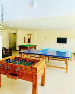 two ping pong tables in a room with at Bangalô Boutique com piscina Privativa in Porto De Galinhas