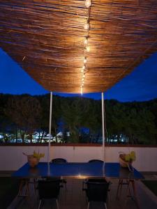 a blue table with chairs under a wooden ceiling at Hotel Petit in Silvi Marina