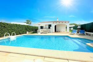 a swimming pool in front of a house at Villa Mar Uno in Cala'n Bosch