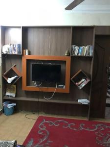 a living room with a flat screen tv on a shelf at Lovely 3-bedroom rental unit.cozy and friendly in Cairo