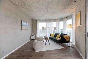 a living room with a couch and a table at Lumen by coliving in Renens