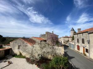 a view of an old town with a building at Maison Dix Tusson in Tusson