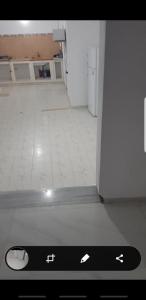 a remote control in a room with a floor at Sousse home in Hammam Sousse