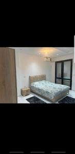 a bedroom with a bed and a couch at Sousse home in Hammam Sousse