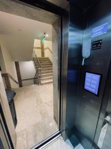 an elevator in a room with a hallway with stairs at Luxurious, self-enter apartment in Jeddah