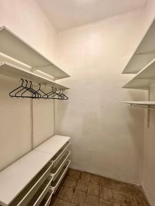 a walk in closet with white shelves at Casa Vanchiglia - Centro in Turin