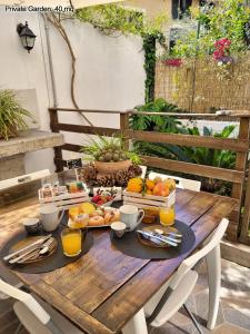 a wooden table with fruit and juice on it at Leoni63 in Palermo