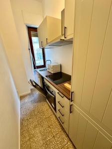 a small kitchen with a sink and a microwave at Casa Vanchiglia - Centro in Turin